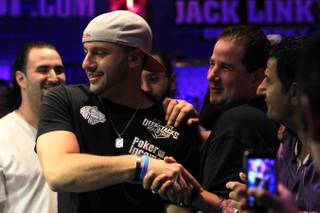 Michael Mizrachi is congratulated by friends after winning the 2012 World Series of Poker $50,000 Players Championship.