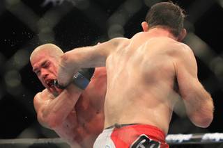 Forrest Griffin nails Tito Ortiz with a left during their light heavyweight fight at UFC 148 Saturday, July 7, 2012 at the MGM Grand Garden Arena. Griffin won a unanimous decision in what was Ortiz's retirement fight.