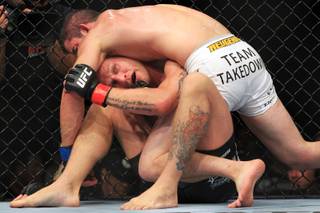 John Alessio gets tied up by Shane Roller during their preliminary bout at UFC 148 Saturday, July 7, 2012 at the MGM Grand Garden Arena. Roller won by decision.