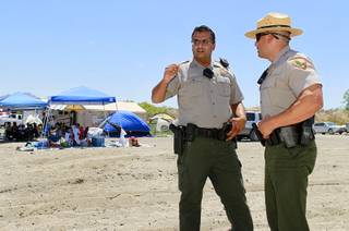 Prashant Lotwala, left, a supervisory park ranger, confers with Randy Lavasseur, assistant chief of support services, as they investigate the drowning of Pablo Hernandez Cortez, 37, and his son, 2-year-old Angel Gabriel Hernandez, at Six-Miler Cove in the Lake Mead National Recreation Area Sunday, July 8, 2012.