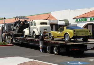 An HBO crew secures cars, once owned by Liberace, onto a car carrier at the Liberace Museum parking lot, Wednesday July 11, 2012. The cars, a 1972 custom Bradley GT and a 1957 London taxi, are on loan to HBO for a project titled "Behind the Candelabra," an official said.
