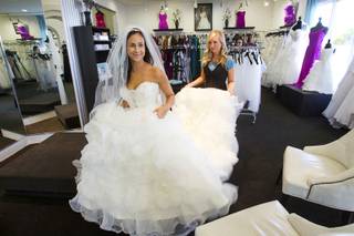 Raquel Mendoza gets help with her train from sales consultant Laura Munford at Celebrations Bridal and Fashion at 3131 South Jones Boulevard Wednesday July 11, 2012. A reality television crew recently filmed at Celebrations in hopes of making a Vegas version of 