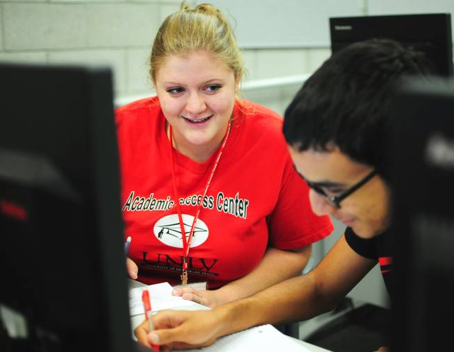 Tutor Megan Bavaro helps Isaac Robinson, 18, with a math problem at UNLV's Summer Bridge program on Tuesday, July 17, 2012. The new program helps incoming freshmen avoid costly remedial math courses by preparing them for five weeks over the summer to pass a math proficiency exam that places them into a college-level math course.