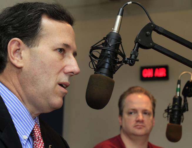 Tom Brown, right, listens as possible 2012 Republican presidential candidate, former U.S. Sen. Rick Santorum of Pennsylvania speaks during a live radio show at WEZS , Tuesday, March 29, 2011 in Laconia, N.H.