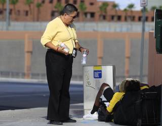 Mindy Torres from HELP of Southern Nevada distributes water to the homeless Thursday, July 19, 2012.