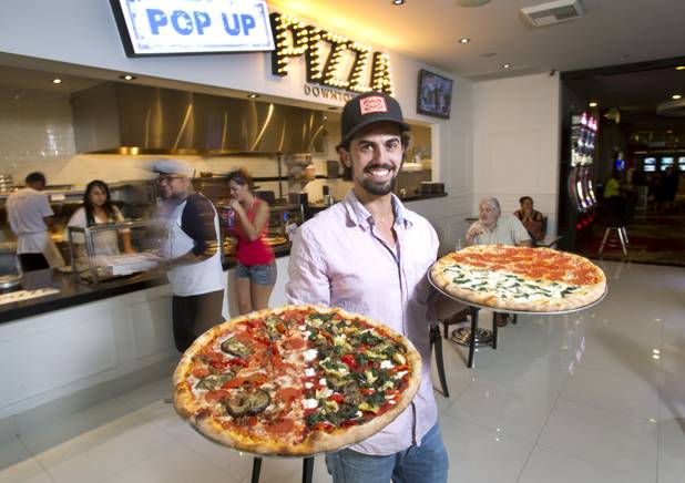 Michael Vakneen poses with pizza at Pop Up Pizza in the Plaza in downtown Las Vegas Sunday, July 22, 2012. Vakeneen is partners with Sam Cherry and Grant Garcia in the business which opened in May. STEVE MARCUS