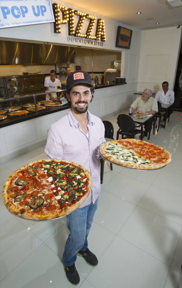 Michael Vakneen poses with pizza at Pop Up Pizza in the Plaza in downtown Las Vegas Sunday, July 22, 2012. Vakeneen is partners with Sam Cherry and Grant Garcia in the business which opened in May. STEVE MARCUS