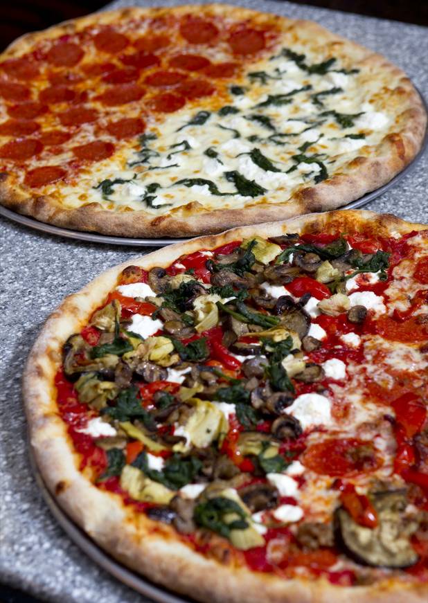 Pizza at Pop Up Pizza in the Plaza in downtown Las Vegas Sunday, July 22, 2012. In the back, the "Main Street" ( pepperoni) and the "White Chapel" (ricotta, mozzarella cheese, sauteed spinach and garlic olive oil). In the foreground, the 'Newport" (roasted eggplant, spinich, peppers and mushrooms) and the "Fremont" ( sausage , bacon, pepperonies and peppers). STEVE MARCUS