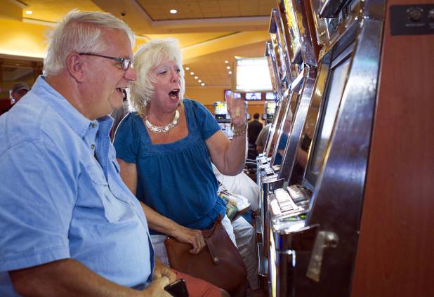 Slot player Babs Duncan celebrates with her husband Jack after picking the winning horse and winning $70 in bonus credits in a virtual horse race at the South Point Thursday, July 26, 2012. The South Point is the first casino in Nevada to implement the virtual race by Bally Technologies. Winners split a total prize pool of $30,000 in bonus credits.