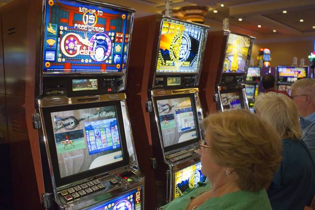 Slot players watch as horses are displayed to the side of their slot game during a virtual horse race at the South Point Thursday, July 26, 2012. The South Point is the first casino in Nevada to implement the Virtual Race by Bally Technologies. There are four races every Thursday and slot players qualify for the races by obtaining 25 points, playing with their club card, within two hours of each race. Winners split a total prize pool of $30,000 in bonus credits.