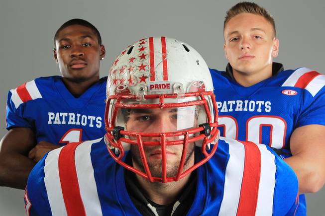 Liberty football players Jay Mitchell, Christopher Noone and Phoenix Uptain Thursday, July 26, 2012.