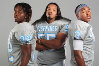 Canyon Springs football players Stephone Revels, Fabian Leos and A.J. Cooper Thursday, July 26, 2012.