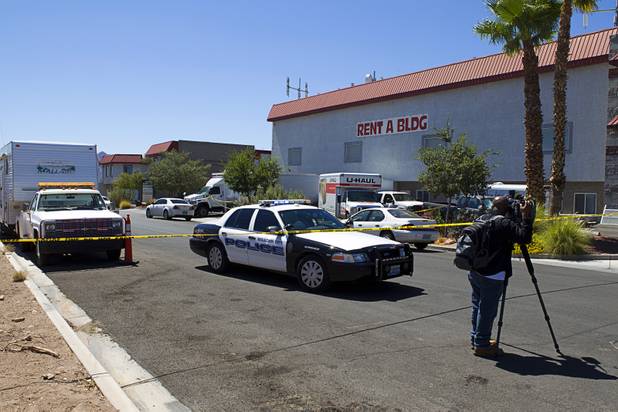 A news photographer takes video of a storage building during a seizure of artwork in Boulder City, Nevada, about 20 miles southeast of Las Vegas, July 27, 2012. The seizure is apparently related to the arrest of German fugitive Ulrich Felix Anton Engler, 51, who was arrested in the Las Vegas area on July 25. Engler is accused of bilking investors of over $100 million using an Internet pyramid scheme.