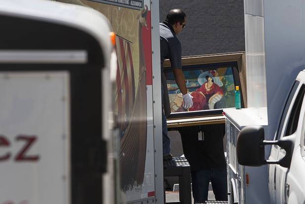 Officials load artwork from a storage building into trucks in Boulder City, Nevada, about 20 miles southeast of Las Vegas, July 27, 2012. The seizure is apparently related to the arrest of German fugitive Ulrich Felix Anton Engler, 51, who was arrested in the Las Vegas area on July 25. Engler is accused of bilking investors of over $100 million using an Internet pyramid scheme.