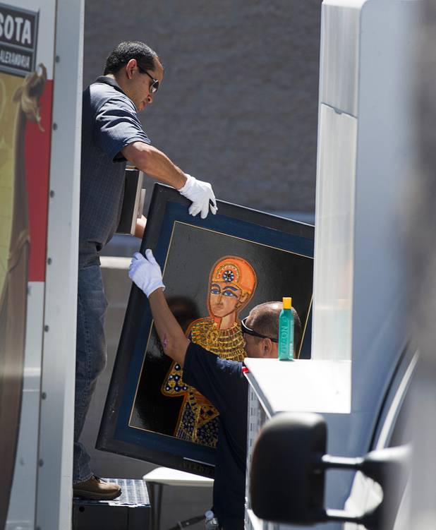 Federal and local law enforcement officials load artwork from a storage building into trucks in Boulder City, Nevada, about 20 miles southeast of Las Vegas, July 27, 2012. The seizure is apparently related to the arrest of German fugitive Ulrich Felix Anton Engler, 51, who was arrested in the Las Vegas area on July 25. Engler is accused of bilking investors of over $100 million using an Internet pyramid scheme.