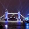 The speedboat, bottom left, carrying the Olympic Flame, heads to Tower Bridge during the Opening Ceremony at the 2012 Summer Olympics, Friday, July 27, 2012, in London. (AP Photo/Vadim Ghirda)