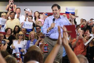 U.S. Sen. Marco Rubio takes the stage during a campaign event for Mitt Romney at Ronnow Elementary school, which Rubio attended from third through fifth grade, Saturday, July 28, 2012.