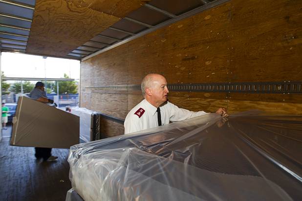 Robert Lloyd, Clark County coordinator for the Salvation Army of Southern Nevada, helps unload a donation of 200 new mattresses at the Salvation Army Shelter on Owens Avenue Monday, July 30, 2012. The donation was the launch of Project Beds for America by WorldBed.