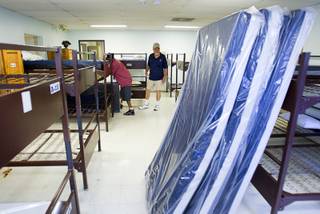 Stan Drabant, center, dorm supervisor, watches as volunteers bring in a donation of 200 new mattresses at the Salvation Army Shelter on Owens Avenue Monday, July 30, 2012. The donation was the launch of Project Beds for America by World Bed. WorldBed, working with government and local charities, hopes to donate 2,000 anti-bacterial, bug-proof and water-proof mattresses to shelters around the Las Vegas Valley.