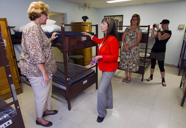 Terri Anderson, left, treasurer of the board for WorldBed, talks with Laura Castro, WorldBed president and executive director, during the donation of 200 new mattresses at the Salvation Army Shelter on Owens Avenue Monday, July 30, 2012. The donation was the launch of Project Beds for America by WorldBed.