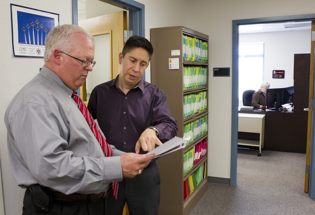 Ross Bryant, left, director of UNLV's Office of Veteran Services, and Navy veteran Daniel Flores look over paperwork for a incoming veteran student at the office Tuesday, July 31, 2012.