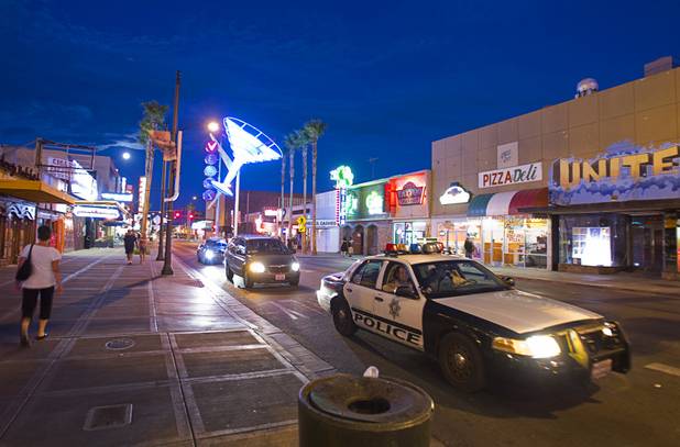 Metro Police officers patrol Fremont Street near Las Vegas Boulevard in downtown Las Vegas Wednesday, August 1, 2012.