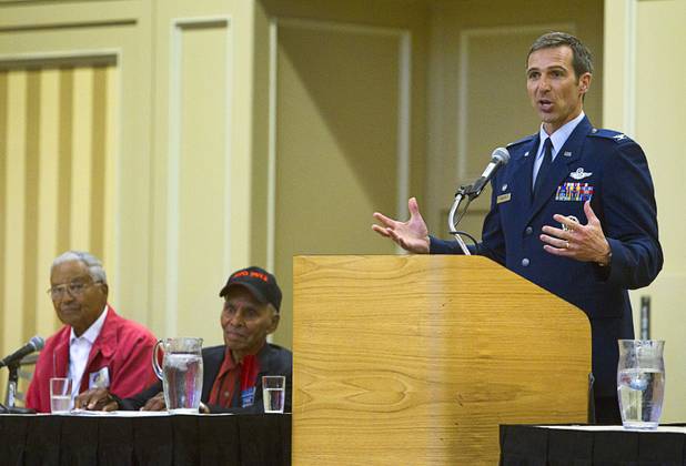 Air Force Col. Bryan Radliff, an F-22 fighter pilot at Elmendorf AFB in Alaska, speaks during the International Black Aerospace Council convention at the Las Vegas Hotel Wednesday, August 1, 2012. Tuskegee Airmen Charles E. McGee, left, and Roscoe C. Brown, Jr. were also part of the panel.