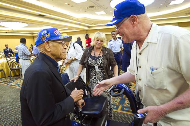 Tuskegee Airman Arthur Hicks, left, chats with Lowell Steward Jr. following a luncheon at the International Black Aerospace Council convention at the Las Vegas Hotel Wednesday, August 1, 2012.