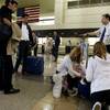An unidentified Transportation Security Administration screener advises passengers to take all loaded cameras and film sensitive materials out of luggage before their luggage is screened at the gates the Los Angeles International Airport Thursday, April 22, 2004.