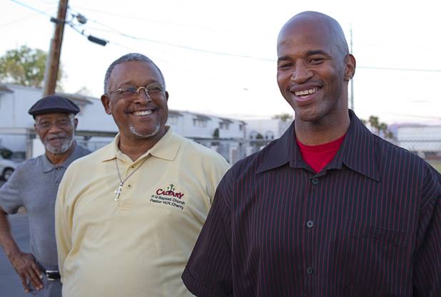 Community leaders Mujahid Ramadan, left, Pastor Willie Cherry, center, of the Pleasant Grove Baptist Church, and Charles Webb, a diversion specialist with the Stay Focused program for at-risk youth, gather in the parking lot of the Desert Gardens Condominiums complex near Martin Luther King Jr. Boulevard and Bonanza Road Monday, Aug. 6, 2012.