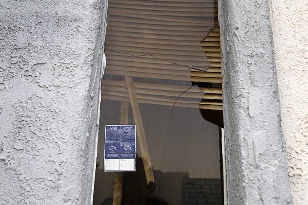 A view of a broken window in a unit at the Desert Gardens Condominiums complex near Martin Luther King Jr. Boulevard and Bonanza Road Monday, Aug. 6, 2012. Of 147 units in the complex, only about 50 are occupied, said a Metro Police officer.