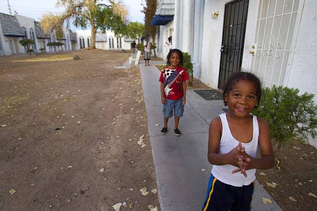Leyon, 4, and Lamar, 5, (no last name given) pose at the Desert Gardens Condominiums complex near Martin Luther King Jr. Boulevard and Bonanza Road Monday, Aug. 6, 2012.