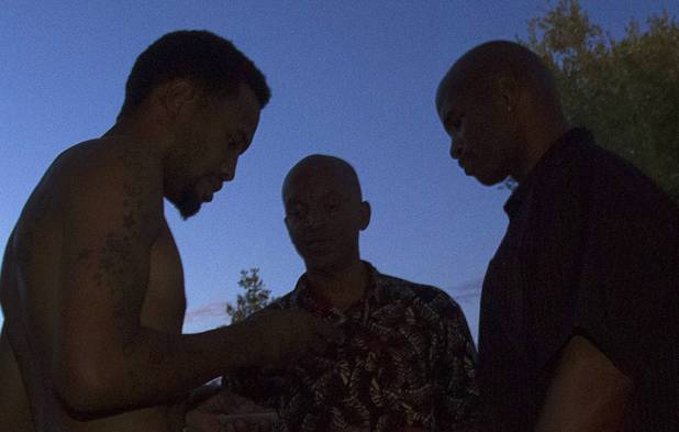 Drayton Barlow, left, talks with community leaders Alonso Jones, center, and Charles Webb at the Desert Gardens Condominiums complex near Martin Luther King Jr. Boulevard and Bonanza Road Monday, Aug. 6, 2012. Barlow said he has no cold air in the upstairs of his unit and no cold water. He also has a newborn daughter and a 17-month-old son living in the apartment.