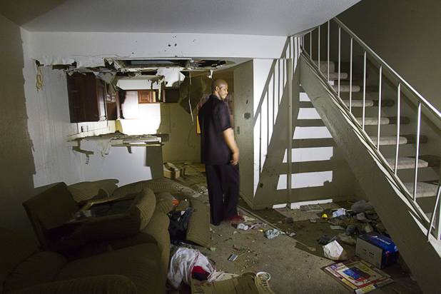 Diversion specialist Charles Webb of the Stay Focused program for at-risk youth walks through an open and vacant unit at the Desert Gardens Condominiums complex near Martin Luther King Jr. Boulevard and Bonanza Road Monday, Aug. 6, 2012.
