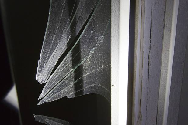Broken glass is shown at a vacant apartment at the Desert Gardens Condominiums complex near Martin Luther King Jr. Boulevard and Bonanza Road Monday, Aug. 6, 2012. Of 147 units in the complex, only about 50 are occupied, said a Metro Police officer.