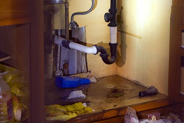 Water drips from kitchen pipes in an open and vacant unit at the Desert Gardens Condominiums complex near Martin Luther King Jr. Boulevard and Bonanza Road Monday, Aug. 6, 2012.