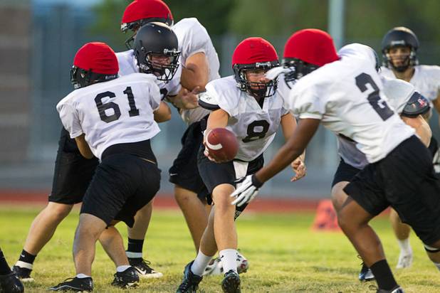 Palo Verde High School's Devin Finn, center, hands the ball to Patrick Gutierrez during practice at the school Tuesday, Aug. 7, 2012. Palo Verde will face Desert Vista High School (Arizona) in the Sollenberger Classic at the University of Phoenix Stadium in Arizona on Aug. 18.