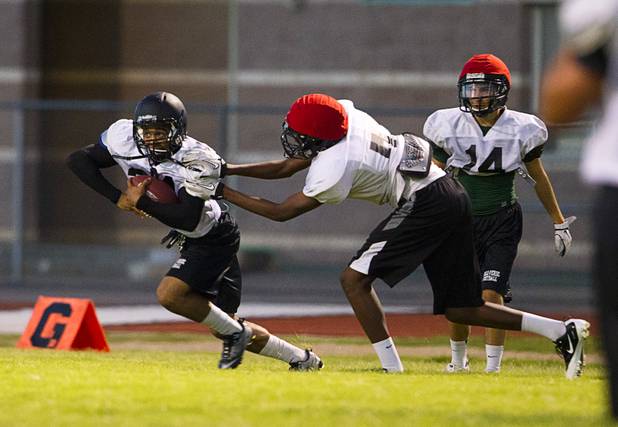 Palo Verde High School's Ryan Beaulieu, left, carries the ball after a pass completion during practice at the school Tuesday, Aug. 7, 2012. Palo Verde will face Desert Vista High School (Arizona) in the Sollenberger Classic at the University of Phoenix Stadium in Arizona on Aug. 18.
