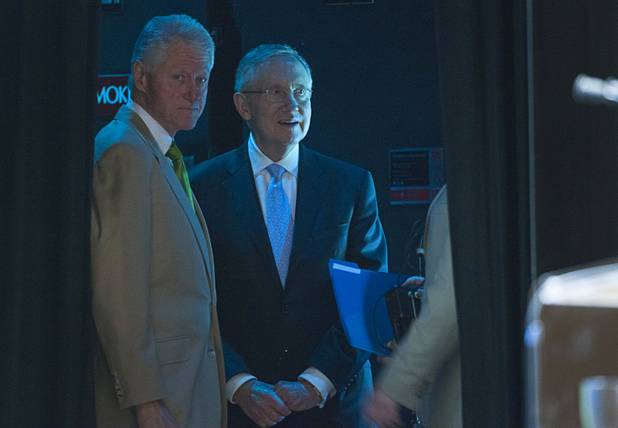 Former President Bill Clinton, left, waits backstage with Senate Majority Leader Harry Reid before giving a keynote address during the National Clean Energy Summit 5.0 at the Bellagio Tuesday, August 7, 2012.
