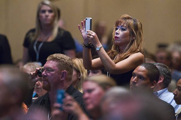 A woman takes a photo as former President Bill Clinton arrives for a keynote address during the National Clean Energy Summit 5.0 at the Bellagio Tuesday, August 7, 2012.
