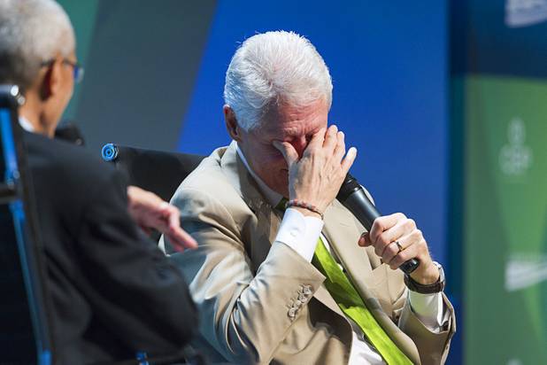 Former President Bill Clinton reacts as John Podesta, left, chairman of the Center for American Progress, says the next question may get him into trouble with his wife, Secretary of State Hillary Clinton, during a "fireside chat" at the National Clean Energy Summit 5.0 in the Bellagio Tuesday, August 7, 2012.