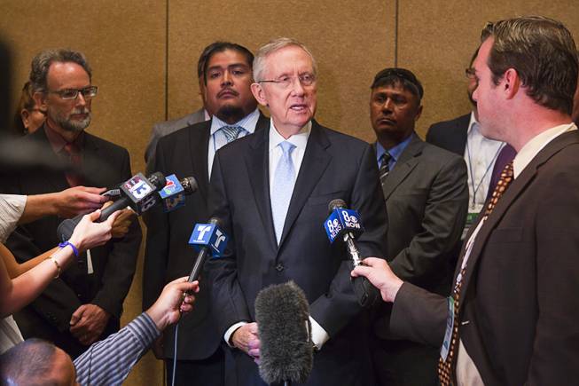 Senate Majority Leader Harry Reid is joined by members of the Moapa band of Paiutes and environmentalists as he calls for the closing of NV Energy's Reid Gardner coal-fired power plant during the National Clean Energy Summit 5.0 at the Bellagio Tuesday, August 7, 2012.