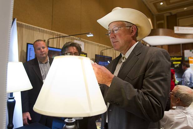 U.S. Secretary of the Interior Ken Salazar looks over lamps with BrightSol LED bulbs during the National Clean Energy Summit 5.0 at the Bellagio Tuesday, August 7, 2012. The DLite bulbs gives off the same amount of light as a 60 watt incandescent bulb but use only 9.5 watts and have an expected lifetime of 1 million hours. The bulbs should be available in stores by the end of the year and cost less than $15.00.