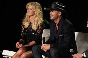 Faith Hill and Tim McGraw listen to a question after announcing their concert series at the Venetian on Tuesday, Aug. 7, 2012.