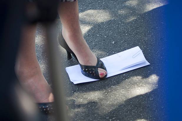 U.S. Congresswoman Shelley Berkley (D-NV) stands on what she said were her prepared remarks during a news conference in the parking lot of Palo Verde High School before a rally for Republican vice presidential candidate Paul Ryan at the school Tuesday, Aug. 14, 2012. Berkley spoke without notes at the news conference. Berkley is running for U.S. Senate against Sen. Dean Heller (R-NV).