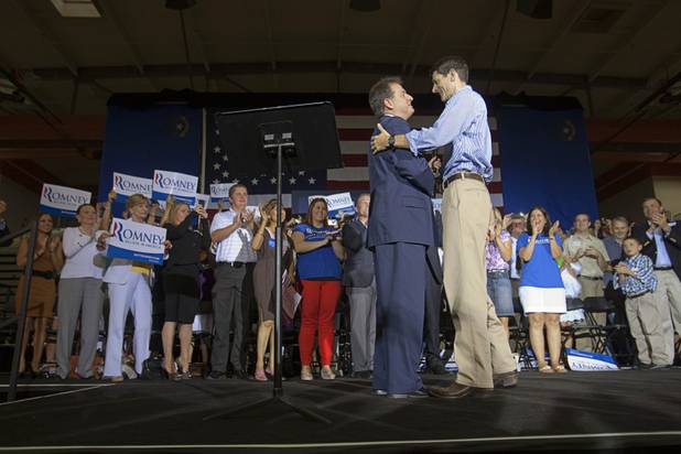 Republican vice presidential candidate Paul Ryan, right, is greeted on stage by Nevada Lt. Governor Brian Krolicki at a rally at Palo Verde High School in Summerlin Tuesday, Aug. 14, 2012.