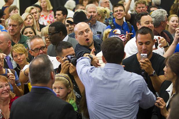 A supporter reaches out to shake hands with Republican vice presidential candidate Paul Ryan during a rally at Palo Verde High School in Summerlin Tuesday, Aug. 14, 2012.