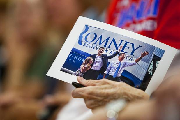 A supporter holds a photo of Republican vice presidential candidate Paul Ryan with Republican presidential candidate Mitt Romney during a rally at Palo Verde High School in Summerlin Tuesday, Aug. 14, 2012.
