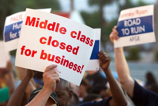 Union members hold up signs as they picket against Republican vice presidential candidate Paul Ryan in front of the Venetian on the Las Vegas Strip Tuesday, Aug. 14, 2012. Ryan was reportedly meeting privately with a small group of supporters at the casino owned by Sheldon Adelson, a billionaire and major donor to Republican campaigns.