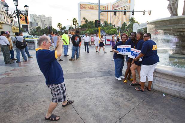 Members of the American Federation of Government Employees union poses for a photo following a rally against Republican vice presidential candidate Paul Ryan in front of the Venetian on the Las Vegas Strip Tuesday, Aug. 14, 2012. Ryan was reportedly meeting privately with a small group of supporters at the casino owned by Sheldon Adelson, a billionaire and major donor to Republican campaigns.
